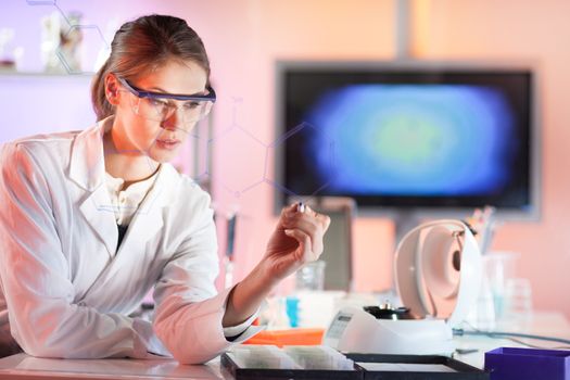 Life science researcher working in laboratory. Portrait of a confident female health care professional in his working environment writing structural chemical formula on a glass board.