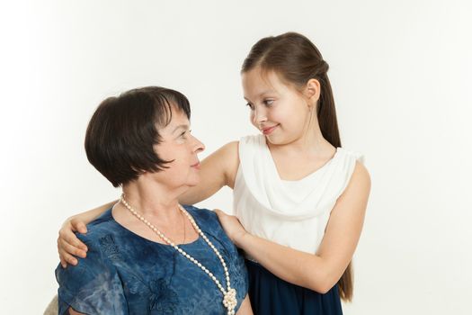 the grandmother and the granddaughter in dresses having embraced