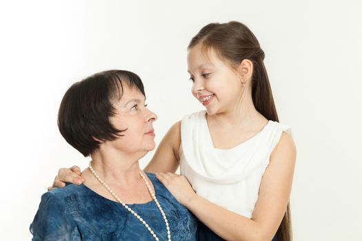 the grandmother and the granddaughter in dresses having embraced