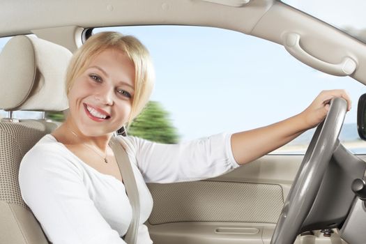 portrait of young beautiful woman sitting in the car