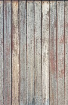 Rustic wooden background made up of vertically placed beautiful aged red wood panels