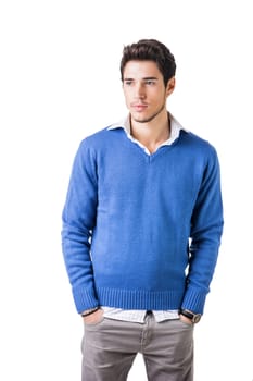 Smiling cool young man with wool sweater on white background looking at camera