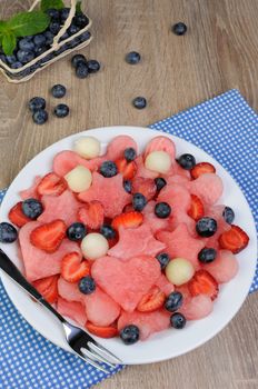 fruit salad of blueberries, watermelon hearts, stars, balls of melon and strawberries