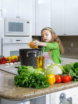 view of young beautiful girl cooking at the kitchen