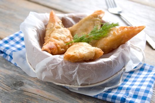 Greek cheese stuffed filo pastry with herbs in a dish 