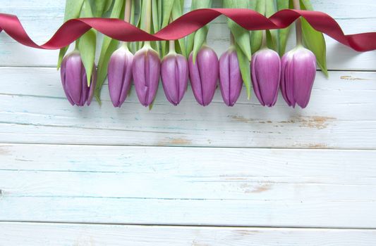 Tulips on a wooden background with space