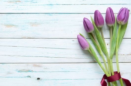 Tulips on a wooden background with space