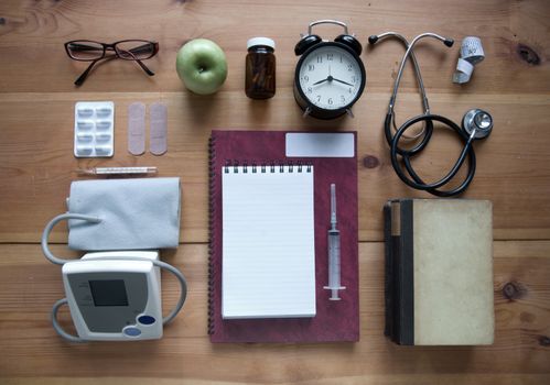 Medical objects laid out on a wooden table 