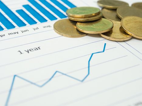 Gold coins and financial reports.  investment concept.  selective focus.