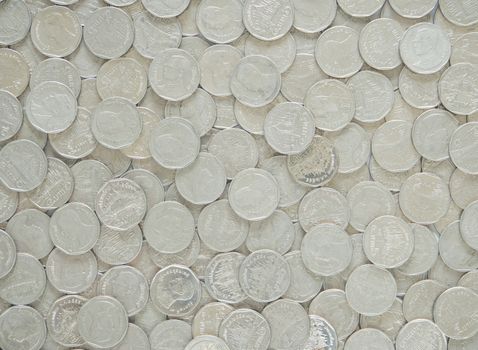 Silver metal coins used to cover the background.