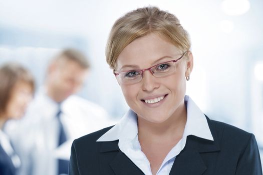 Portrait of young beautiful woman in office environment