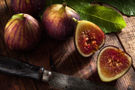 close up view of fresh figs and knife on color back