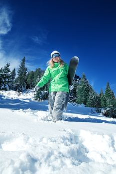 view of a young girl snowboarding in winter environment