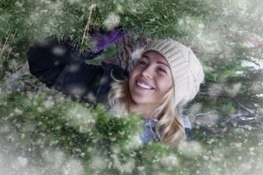 Portrait of young beautiful woman on winter outdoor background