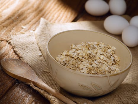 close up view of oat flakes with eggs on color back