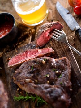 close up view on nice fresh steak on color background