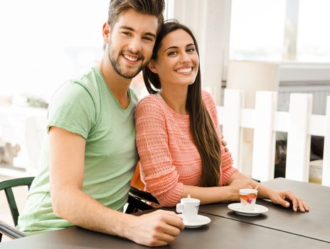 Youg couple at the local coffee shop drinking a coffee