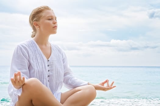 Portrait of young woman practicing yoga in summer environment