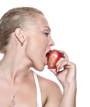 portrait of young beautiful woman biting apple on  white back