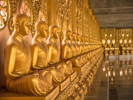 Alignment of Buddhas statues in temple, Thailand