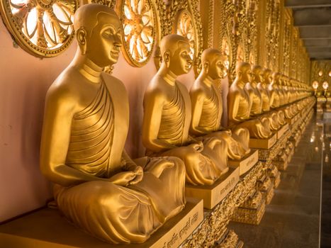 Alignment of Buddhas statues in temple, Thailand