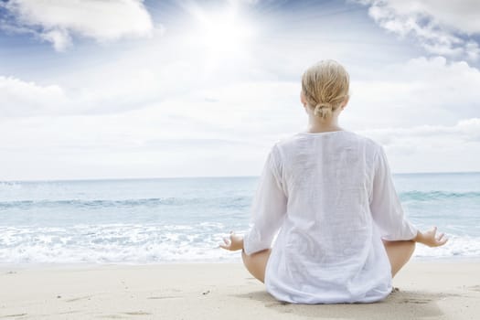 Portrait of young woman practicing yoga in summer environment