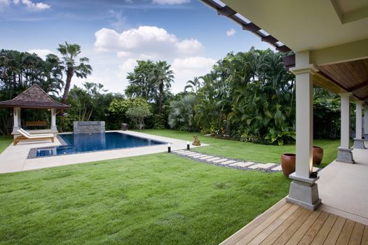 Panoramic view of nice tropic luxury garden with swimming pool