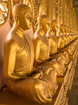 Alignment of Buddhas statues in temple, Thailand
