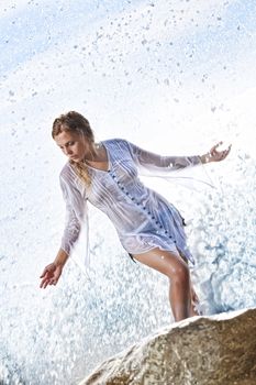 portrait of young beautiful water splashed  woman  on color  back