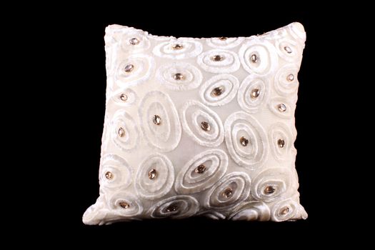 A luxurious pillow with gemstones and a white fabric with modern pattern