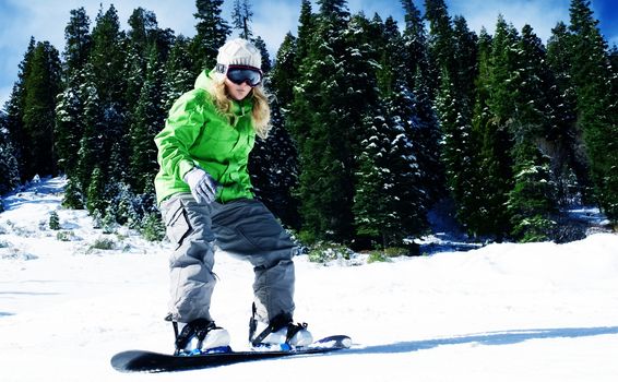 view of a young girl snowboarding in winter environment