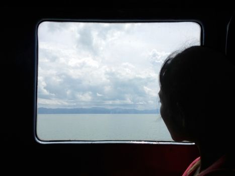 young woman traveling and looking out window