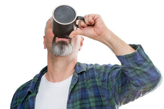 Single middle aged bearded man in flannel and tee shirt gulping down the last drop of coffee from a dark mug over white background