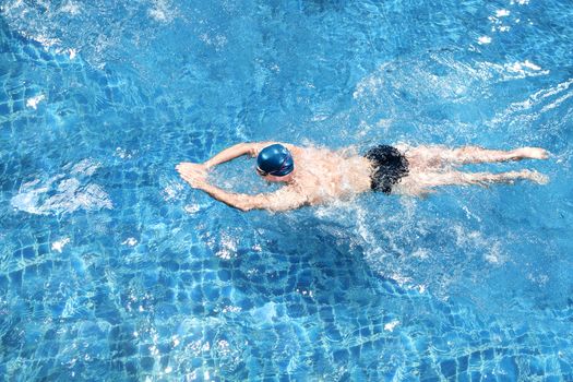 portrait of young man swimming in the pool