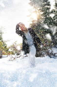 Portrait of young beautiful woman on winter outdoor background