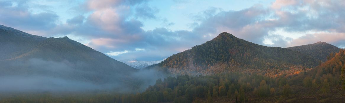 sunrise in autumn taiga and mountains