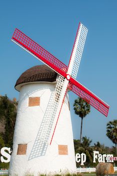 white red wind turbine against clear blue sky