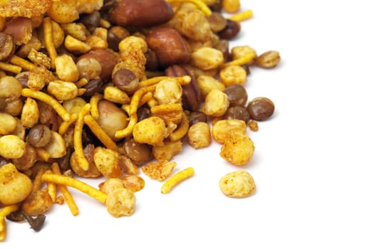 Pile of dry roasted Indian snack mix, isolated over white