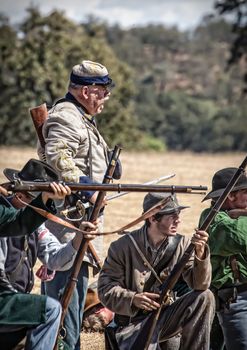 Confederate soldiers reload and fire at the Union during a Civil War Reenactment at Anderson, California.
Photo taken on: September 27th, 2014