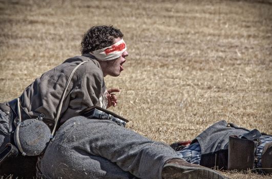 A Confederate  soldiers are laying wounded or dead on the battlefield during a Civil War Reenactment at Anderson, California.
Photo taken on: September 27th, 2014