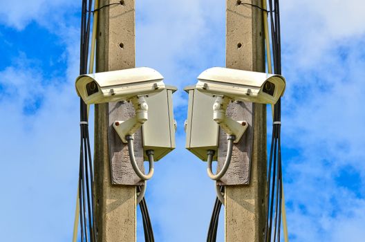 Two closed circuit camera on blue sky background