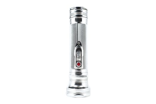 Old-fashioned vintage silver-coloured flashlight on an white background