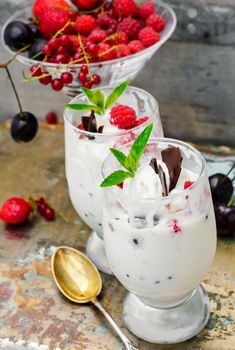 Dairy ice cream with strawberries,currants and raspberries in the glass