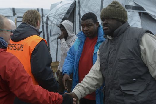 FRANCE, Calais: Employees of the prefecture of Calais and volunteers are seen in the Jungle migrant camp of Calais, northern France, on February 26, 2016, as they inform migrants on the eviction order, after a French court gave the green light to plans to evacuate hundreds of migrants from the southern part of the notorious camp.
