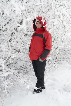 Pretty winter girl in the snow forest