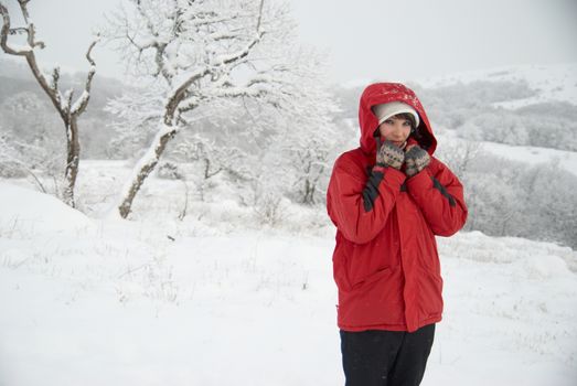 Pretty winter girl in the snow forest