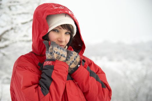 Pretty winter girl in the snow forest