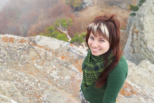 Pretty girl on the rock with the mist