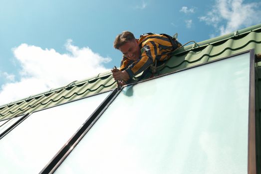 Erector of solar water heating system on the roof.