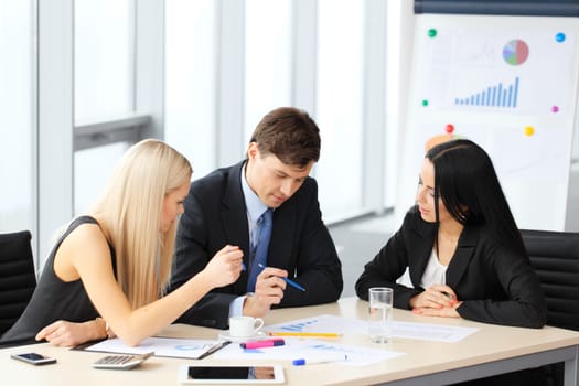 Teamwork of business people discussing reports in office